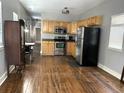 Kitchen with stainless steel appliances, wooden cabinets, and view to the adjacent living area at 7 Dingle St, Charleston, SC 29403