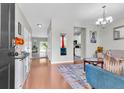 Bright living room features hardwood floors, modern decor, and an open layout flowing into the kitchen at 7644 High Maple Cir, North Charleston, SC 29418