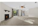 Spacious living room with a cozy fireplace and sliding glass doors that let in natural light at 7950 Parklane Ct # C, North Charleston, SC 29418