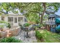 Serene backyard with a patio, play area, outdoor seating, and lush landscaping for relaxing and entertaining at 938 Sea Gull Dr, Mount Pleasant, SC 29464