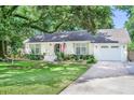 Inviting home featuring a manicured lawn, white exterior, shuttered windows, and a welcoming front porch at 938 Sea Gull Dr, Mount Pleasant, SC 29464
