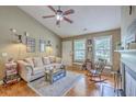 Bright living room featuring a comfortable sofa, ceiling fan, and natural light from multiple windows at 1004 Providence Way, Summerville, SC 29483