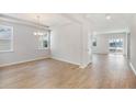 Bright dining room featuring beautiful wood floors, modern chandelier and lots of natural light at 1029 Riverbed Retreat Ln, Summerville, SC 29485