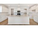 Bright, modern kitchen with white cabinets, quartz countertops, stainless steel appliances, and a center island at 1029 Riverbed Retreat Ln, Summerville, SC 29485