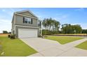 Inviting two-story home with a two-car garage and green lawn set against a clear blue sky at 1035 Forrest Creek Dr, Summerville, SC 29483