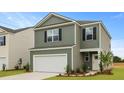 Pleasant two-story home with a two-car garage and manicured lawn on a sunny day in a peaceful neighborhood at 1035 Forrest Creek Dr, Summerville, SC 29483