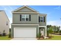 Attractive two-story home with a two-car garage, black shutters, and a well-kept lawn under a clear sky at 1035 Forrest Creek Dr, Summerville, SC 29483