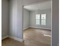 Living room with hardwood floors, natural lighting, and neutral paint ready for customization at 1051 Scotch Bonnet Way, Summerville, SC 29485