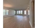 Spacious living room featuring hardwood floors and multiple windows providing ample natural light at 1051 Scotch Bonnet Way, Summerville, SC 29485