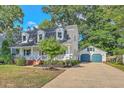 View of home with a detached two-car garage and a long driveway at 106 Cicero Ct, Goose Creek, SC 29445