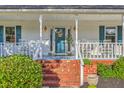 Inviting front porch with rocking chairs and a welcome pineapple on the front door at 106 Cicero Ct, Goose Creek, SC 29445