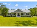 Lovely single-Gathering home with a metal roof, covered front porch, and a well-maintained green lawn at 110 Huntington Ct, Walterboro, SC 29488
