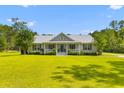 Charming one-story home with a welcoming front porch and beautifully manicured lawn and garden at 110 Huntington Ct, Walterboro, SC 29488