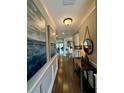 Elegant hallway with hardwood floors, neutral walls, decorative mirrors and attractive wall decor at 114 Magnolia House Dr, Summerville, SC 29486