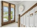 Bright entryway showcasing double doors with roller shades and stairway at 1244 Crooked Oak Rd, Charleston, SC 29492