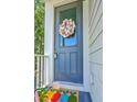 A stylish front door adorned with a floral wreath and a pineapple doormat at 129 Howard Mary Dr # A, Charleston, SC 29412