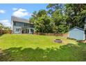 Spacious backyard with a fire pit, storage shed, and a lush green lawn, perfect for entertaining at 1300 Enfield Ln, Mount Pleasant, SC 29466