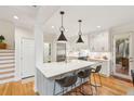 Spacious white kitchen with a large center island, modern appliances, and stylish pendant lighting at 132 Turnberry Dr, Johns Island, SC 29455