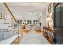 Bright living room with skylight, hardwood floors, fireplace, and french doors leading to the backyard at 132 Turnberry Dr, Johns Island, SC 29455
