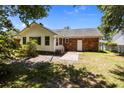 Private backyard featuring a brick patio, a white door and a well-maintained lawn with mature trees providing shade at 133 Bramwell Dr, Summerville, SC 29485