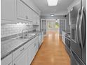 Modern kitchen with white cabinets, stainless steel appliances, and granite countertops offers a sleek design at 133 Bramwell Dr, Summerville, SC 29485