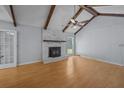 Spacious living room featuring a fireplace, wood beams, and ample natural light from the large window at 133 Bramwell Dr, Summerville, SC 29485