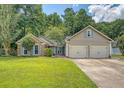Landscaped exterior view of a brick and siding home with a large front yard and two car garage at 138 Wainwright Manor, Summerville, SC 29485