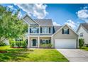Beautiful home featuring a well-manicured lawn, two-car garage, and inviting front porch at 170 Highwoods Plantation Ave, Summerville, SC 29485