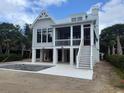 New construction home with a concrete patio and empty pool at 1727 Atlantic Ave, Sullivans Island, SC 29482