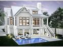 Expansive backyard featuring a modern pool, lounging area, and a covered porch at 1727 Atlantic Ave, Sullivans Island, SC 29482