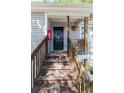 Welcoming front door with a floral wreath, wooden stairs, and fire extinguisher at 19 Rudwick Cir, Goose Creek, SC 29445