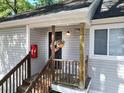Inviting front door with a hanging flower basket and wooden stairs at 19 Rudwick Cir, Goose Creek, SC 29445
