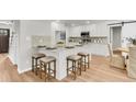Bright, modern kitchen features white cabinetry, a center island with seating, and stainless steel appliances at 220 Runnymede Ln, Summerville, SC 29485