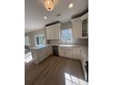 Spacious kitchen featuring a large island, stainless appliances, and a farmhouse sink at 308 Tidal Rice Ct, Wando, SC 29492