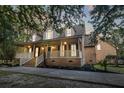 Beautiful exterior view of a brick home with a covered porch and manicured landscaping at 3385 Wayland Dr, Ladson, SC 29456