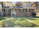 Well maintained brick home with a green lawn, black shutters, and inviting front entrance in a desirable neighborhood at 3627 Marginal Rd, Mount Pleasant, SC 29466