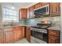 Modern kitchen features stainless steel appliances, granite countertops, stylish backsplash, and ample wood cabinetry at 3627 Marginal Rd, Mount Pleasant, SC 29466