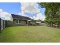 Spacious backyard featuring a gazebo, green grass, and wood fencing perfect for outdoor entertaining at 3806 Sourwood Ct, Ladson, SC 29456