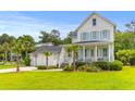 Attractive two-story home with a detached garage, palm trees, and a spacious front lawn at 3870 Fifle St, Mount Pleasant, SC 29466