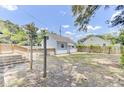 Expansive backyard featuring a detached garage, a wooden deck, and grassy lawn at 4756 Churchill Rd, North Charleston, SC 29405