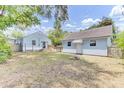 Spacious backyard with a detached garage, deck, and fire pit at 4756 Churchill Rd, North Charleston, SC 29405
