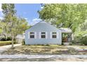 Charming light blue two-story home with landscaped yard, mature trees, and covered porch at 4756 Churchill Rd, North Charleston, SC 29405