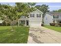 Attractive two-story home with a well-manicured lawn and spacious driveway leading to a two-car garage at 4949 Serene Ln, Hollywood, SC 29449
