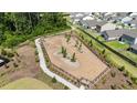 Aerial view of a fenced dog park with walking path and young trees at 5305 Bending Flats Way, Summerville, SC 29485