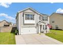 Attractive two-story home with grey siding, attached garage, and well-maintained lawn at 613 Ravens Wood Rd, Summerville, SC 29486