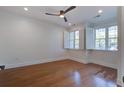 Bright bedroom with hardwood floors, recessed lighting, and windows fitted with classic white shutters at 656 Coleman Blvd # 402, Mount Pleasant, SC 29464