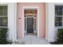 Inviting front entry with a stylish black door, elegant columns, and a warm, welcoming light fixture at 656 Coleman Blvd # 402, Mount Pleasant, SC 29464