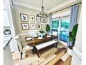 Inviting dining room with a farmhouse-style table, bench, and tasteful decor at 700 Daniel Ellis Dr # 2203, Charleston, SC 29412