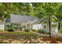 Charming one-story home with an attached garage and beautifully landscaped front yard with a palm tree at 9117 Woodcreek Ct, North Charleston, SC 29406
