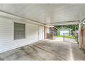 Spacious carport featuring a window and white door, providing ample covered parking at 113 Jackson Rd, Ladson, SC 29456